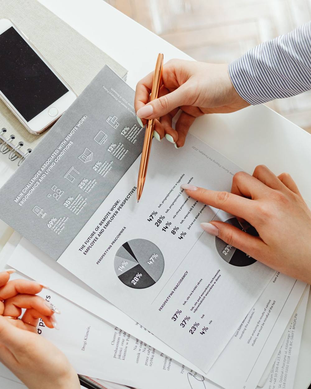 A desk with printed statements, a notebook and a pencil during a planning review.